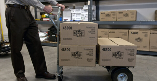 Boxes stacked on push cart with wheels