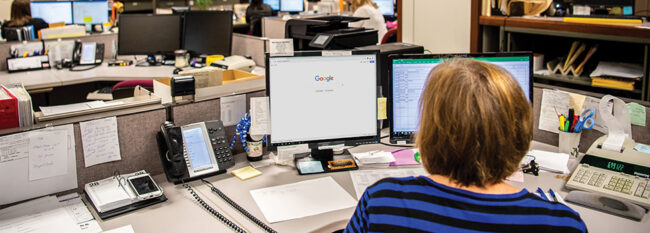 Woman searches Internet at work computer