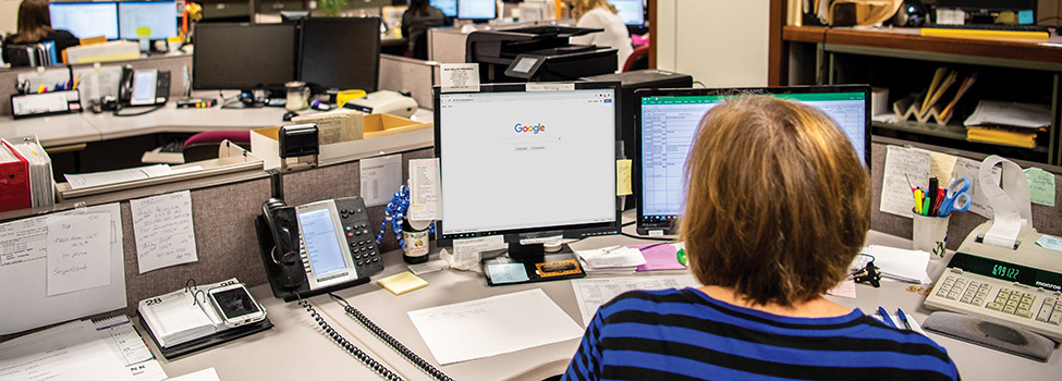 Woman searches Internet at work computer