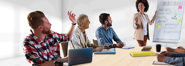 Small group of casually dressed colleagues meets in conference room to discuss project goals
