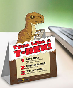 Pop-up table tent of Type Like a T-rex standing on desk near keyboard