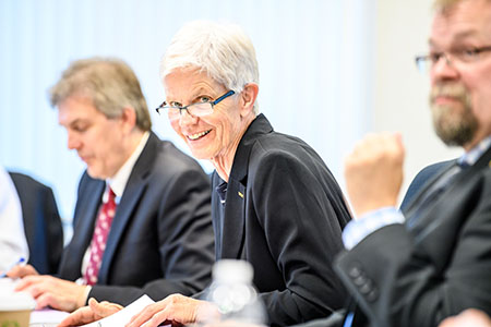 During a board meeting, Marcia Ward speaks.