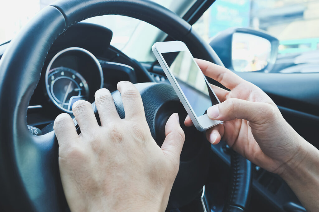image of using a mobile phone inside of a car.