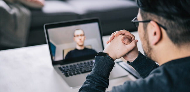Public Safety Employee Assistance Program Brochure Over-the-shoulder view of man during video consultation session