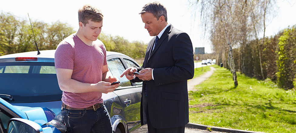 Two Drivers Exchange Insurance Details After Accident Using Mobile Phones