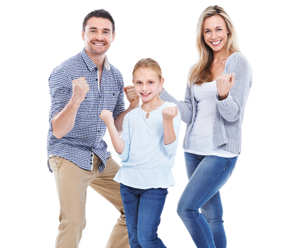 Studio shot of a happy family with their hands in fists smiling at the camera against a white background