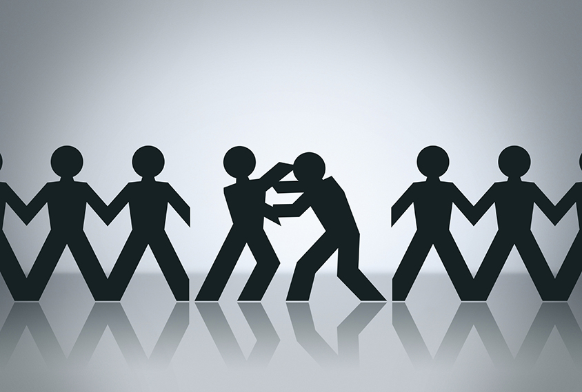 Illustration shows paper cutouts of people in a line, middle two are fighting