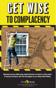 Man paints window trim while half hanging off ladder; shadow shows him falling off. Text: Get Wise to Complacency