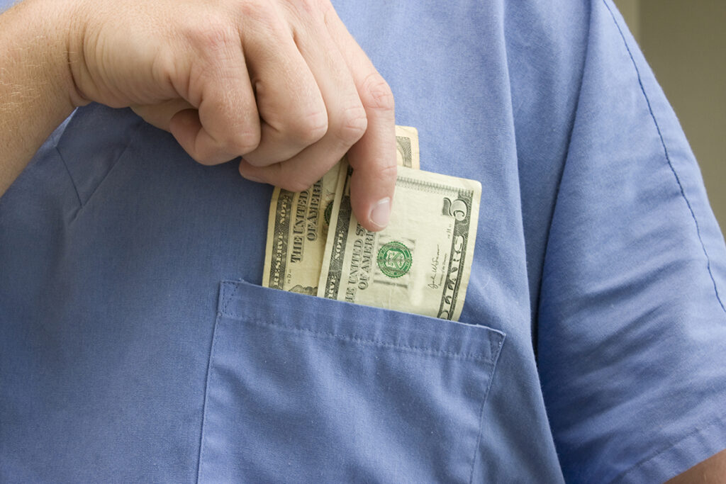 Employee placing money in his pocket