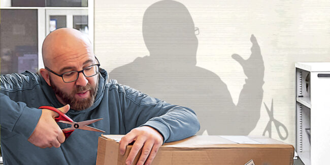 Man opens box using inappropriate tool. Shadow shows him getting cut.