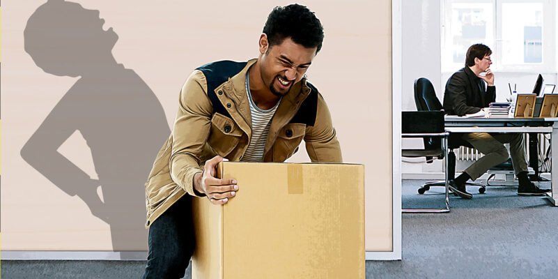 Shows man lifting a large, heavy box with co-worker in background. Shadow shows man's back strained from lift.