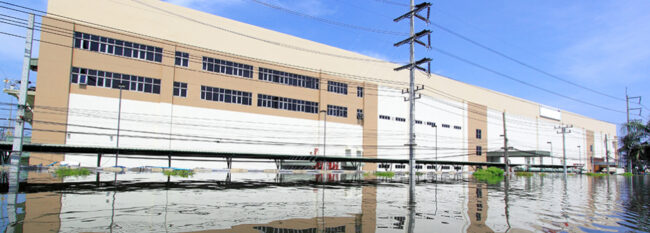 Heavy flooding in streets surrounding industrial buildings