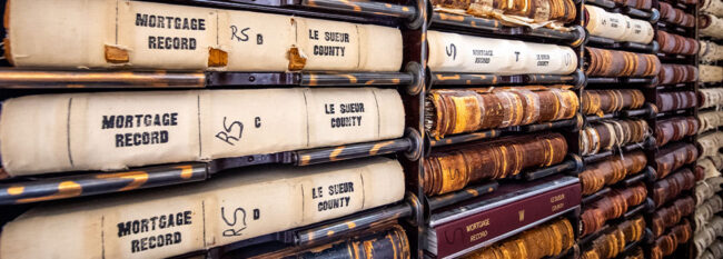 Historical records placed on shelf. Reads "mortgage records" and "Le Sueur County."