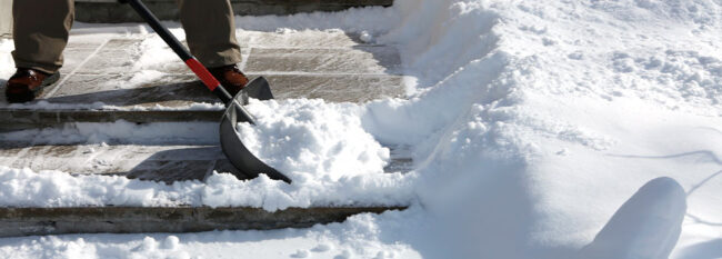 Stairs being shovel to remove snow.