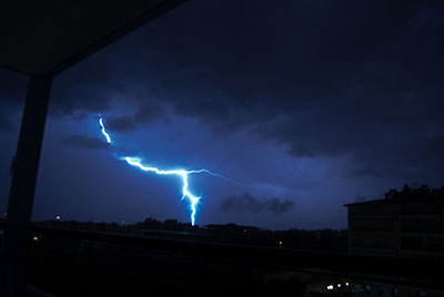 Night sky showing thunder clouds and bolt of lightning