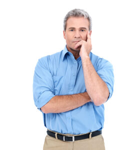 Portrait of an experienced businessman looking at you seriously while isolated on white
