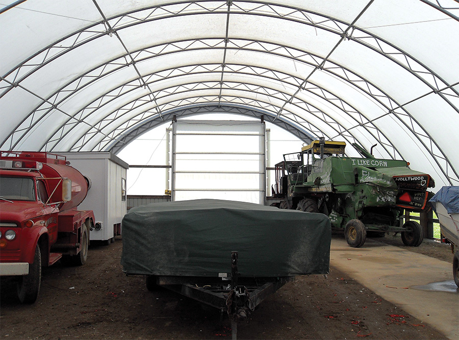 Various vehicle types stored in a large pole barn