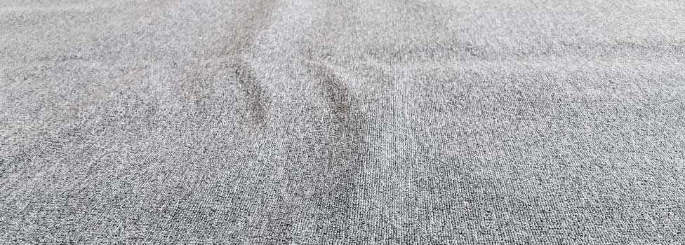 Carpet with raised bubbles or wrinkles.