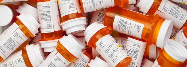 Pile of prescription pill bottles.