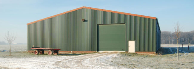 green garage/out building in the winter.