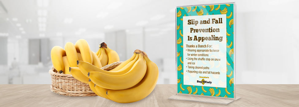 Bananas in a basket on an office table. Sign with a banana pattern reads 