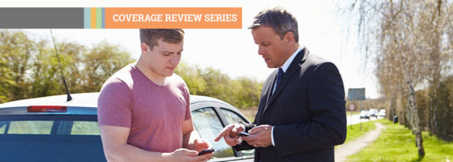 Coverage Review Series - Two man talking by car