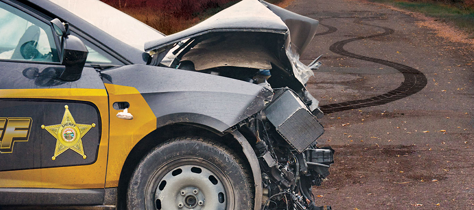 Sheriff's squad front end damaged and tire skid marks on road. Text: You Can Only Help If You Get There