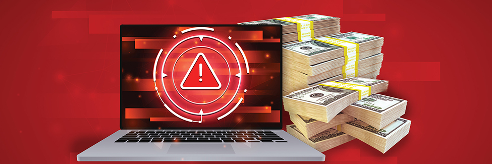 Open laptop with red caution triangle on screen with pile of cash behind laptop
