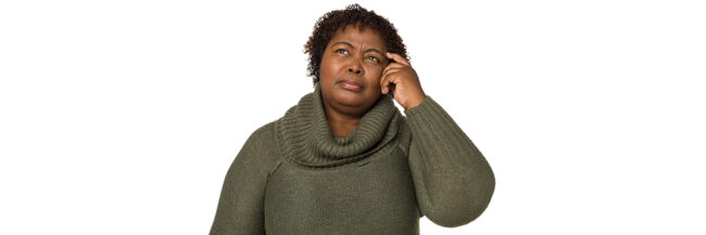 Portrait of a mature woman on a white background with a confused expression while scratching her head.