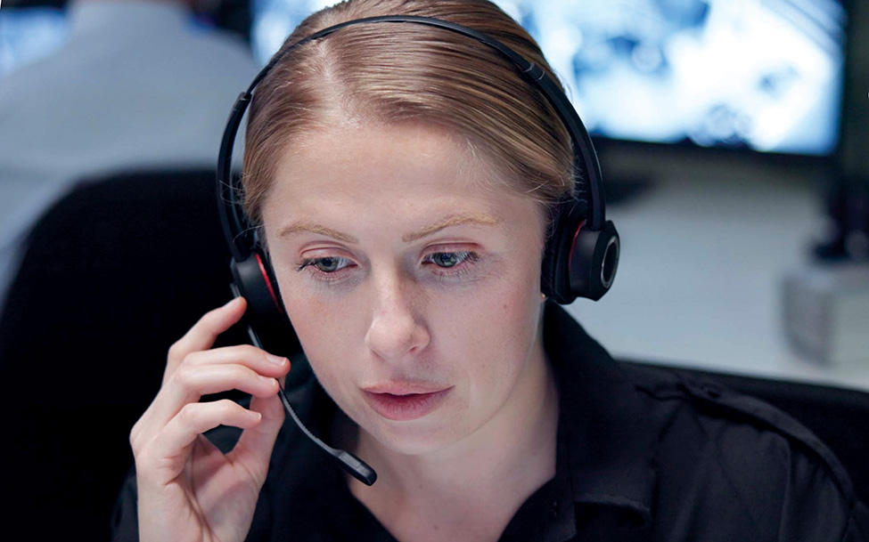 White woman answers calls at public safety dispatch center