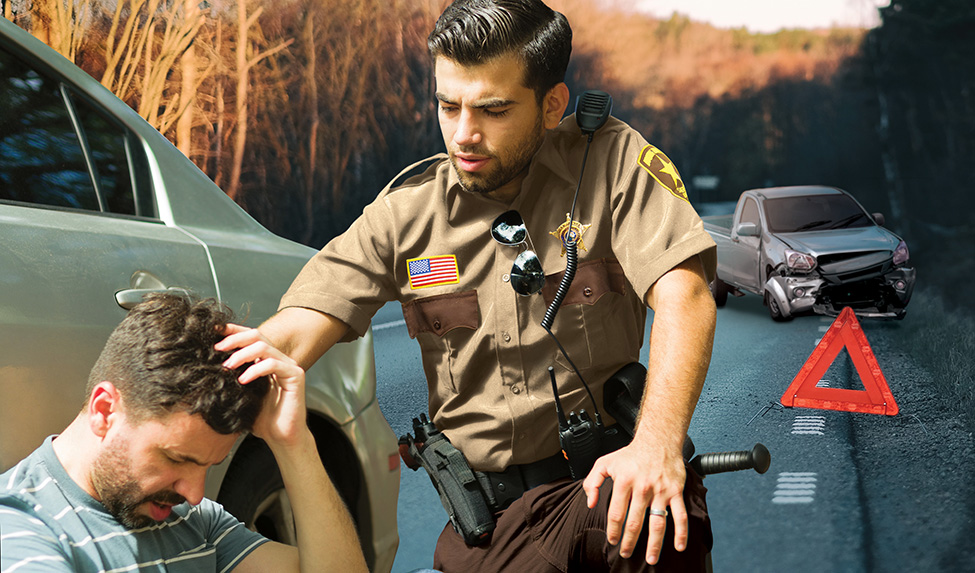 Deputy sheriff attends to person injured in auto accident on side of the road.