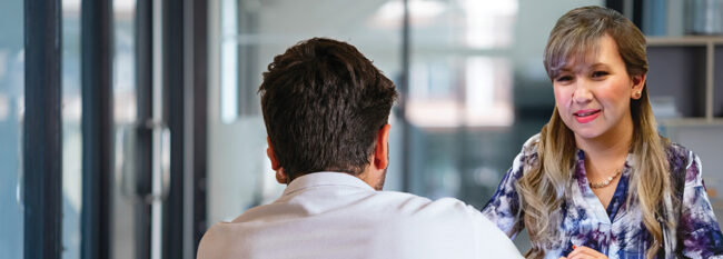 Businesswoman meets with male employee in office setting