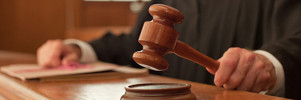 Judge holding gavel in courtroom