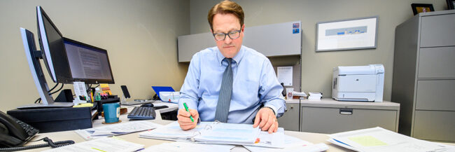 Steve Nelson works at his desk at MCIT headquarters