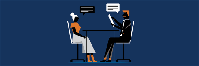 Man and woman in conversation while seated at a table