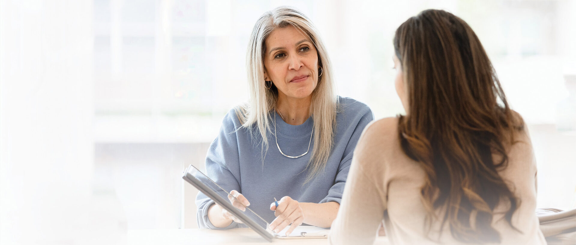 Female business woman talks with an employee against a blurred background